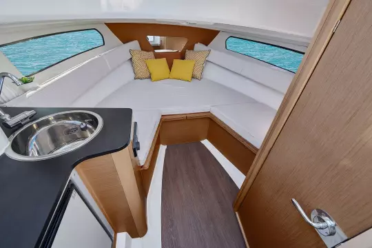 Jeanneau Cap Camarat 7.5 WA - cabin with port side galley and starboard side toilet compartment