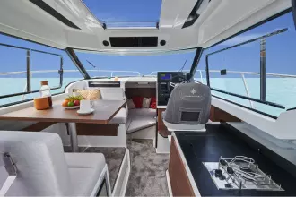 Jeanneau Merry Fisher 795 Series 2 - wheelhouse with port side saloon seating and starboard side helm position and galley