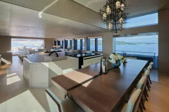 Main Deck Dining Area With 2 Large Opening Glass Doors And Guest Staircase