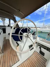Steering wheel of 2011 Jeanneau Sun Odyssey 409 sailboat, docked in a marina.