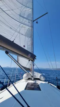 Sailing on a 2011 Jeanneau Sun Odyssey 409 with clear blue skies.