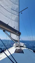 Sailing on a 2011 Jeanneau Sun Odyssey 409 with clear blue skies.