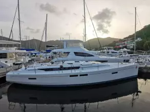 2017 Jeanneau Sun Odyssey 469 sailboat docked in a marina at sunset.