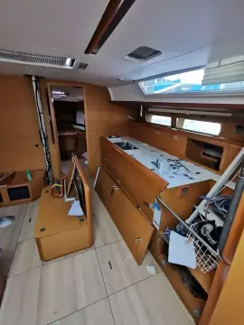 Interior of 2017 Jeanneau Sun Odyssey 469 sailboat with disorganized cabin.