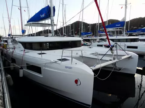 2020 Lagoon 46 catamaran docked in marina, featuring sleek design and spacious deck.