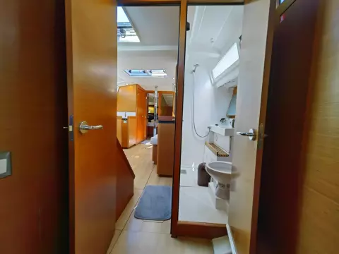 Interior of 2019 Jeanneau Sun Odyssey 440 yacht, featuring bathroom and cabin area.