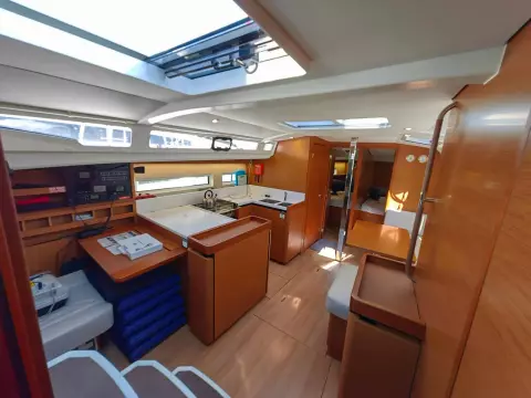 Interior of 2019 Jeanneau Sun Odyssey 440 sailboat, featuring modern kitchen and seating area.