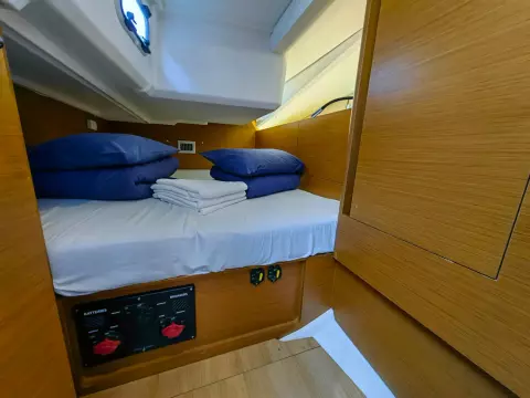 Cabin interior of 2019 Jeanneau Sun Odyssey 440 with neatly arranged bedding.