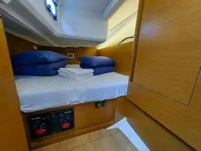 Cabin interior of 2019 Jeanneau Sun Odyssey 440 with neatly arranged bedding.