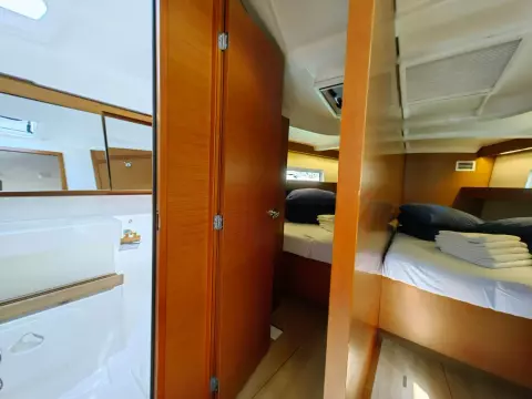 Interior of 2019 Jeanneau Sun Odyssey 440 yacht, featuring cozy cabin and modern wood finishes.