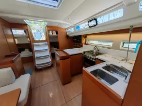 Interior of 2019 Jeanneau Sun Odyssey 440 sailboat, featuring modern kitchen and seating area.