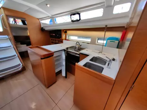 Interior of 2019 Jeanneau Sun Odyssey 440 yacht, featuring modern kitchen and sleek design.