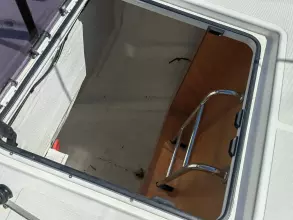 Hatch opening on Jeanneau Sun Odyssey 440 sailboat, 2019 model, with ladder and storage space.