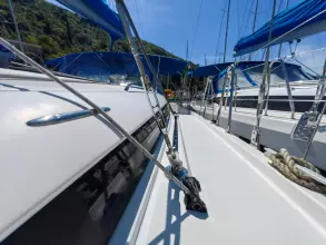 2019 Jeanneau Sun Odyssey 440 sailboat deck with blue canopies and rigging, docked in marina.