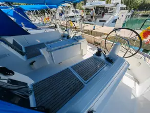 2019 Jeanneau Sun Odyssey 440 sailboat cockpit with dual steering wheels, docked at marina.
