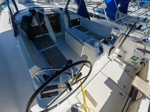 2019 Jeanneau Sun Odyssey 440 cockpit with steering wheel and seating area.