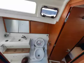 Bathroom interior of 2019 Jeanneau Sun Odyssey 440 yacht, featuring modern fixtures and wood accents.