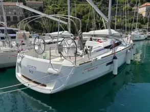 2019 Jeanneau Sun Odyssey 479 sailboat docked in a marina, featuring dual steering wheels.