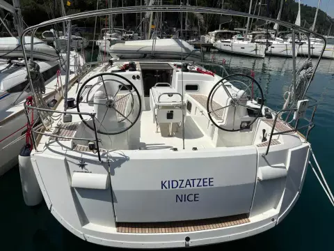 2019 Jeanneau Sun Odyssey 479 sailboat docked in marina, rear view with dual steering wheels.