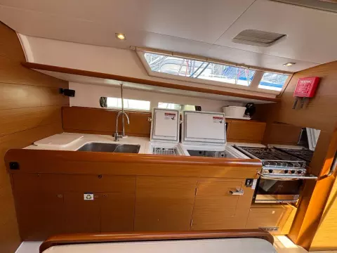 Interior of 2019 Jeanneau Sun Odyssey 479 yacht kitchen with modern amenities.