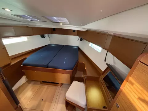 2019 Jeanneau Sun Odyssey 479 cabin with double bed and wooden interior.
