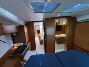 Interior of 2019 Jeanneau Sun Odyssey 479 yacht, featuring modern wood finish and spacious layout.