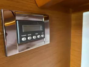 Control panel on Jeanneau Sun Odyssey 479 yacht, 2019 model, with wood finish background.