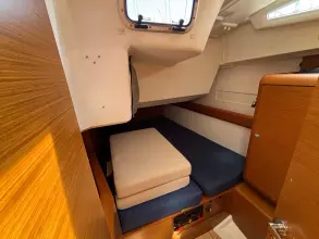 Cozy cabin interior of 2019 Jeanneau Sun Odyssey 479 sailboat with wooden finish.