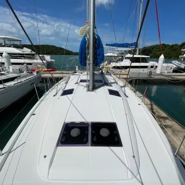 2020 Jeanneau Sun Odyssey 440 sailboat docked at a marina, surrounded by other yachts.