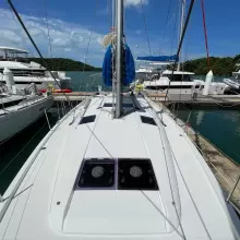 2020 Jeanneau Sun Odyssey 440 sailboat docked at a marina, surrounded by other yachts.