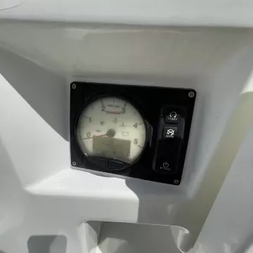 Instrument panel of 2020 Jeanneau Sun Odyssey 440 sailboat, featuring tachometer and control buttons.