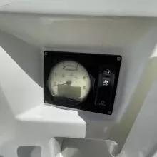 Instrument panel of 2020 Jeanneau Sun Odyssey 440 sailboat, featuring tachometer and control buttons.