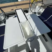 Cockpit table on 2020 Jeanneau Sun Odyssey 440 yacht, open with storage compartment.