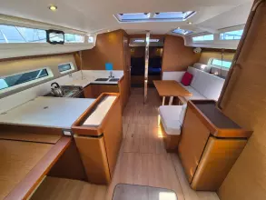 Interior of 2020 Jeanneau Sun Odyssey 440 yacht, featuring modern kitchen and seating area.