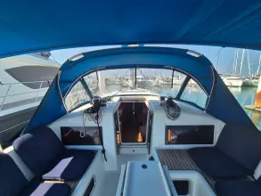 2020 Jeanneau Sun Odyssey 440 yacht cockpit with blue canopy, docked at marina.