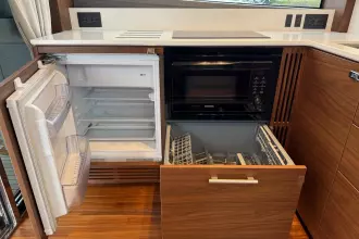Modern kitchen in 2024 Princess F50 yacht with fridge, microwave, and dishwasher.