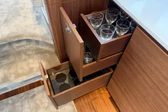 Luxury yacht interior with wooden drawers storing glassware, Princess F50 2024 model.