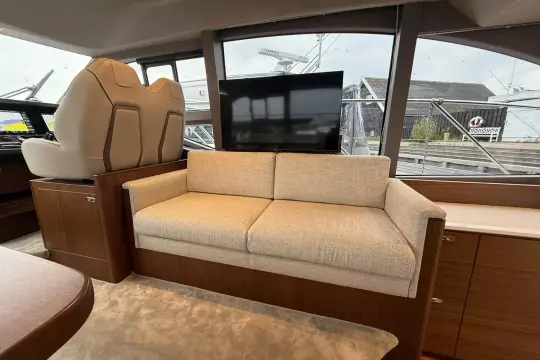 Luxurious interior of 2024 Princess F50 yacht with beige sofa and modern design.