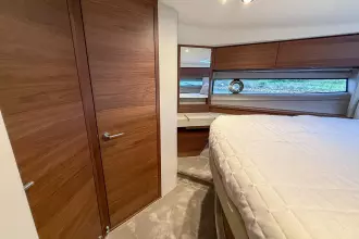 Luxurious 2024 Princess F50 yacht cabin with elegant wood finishes and modern design.