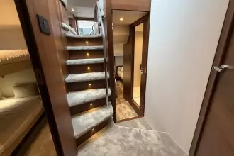 Luxurious interior of 2024 Princess F50 yacht with carpeted stairs and cozy cabin.