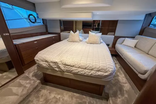 Luxurious 2024 Princess F50 yacht bedroom with elegant bedding and modern furnishings.
