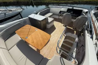 Luxurious 2024 Princess F50 yacht interior with elegant seating and wooden table.