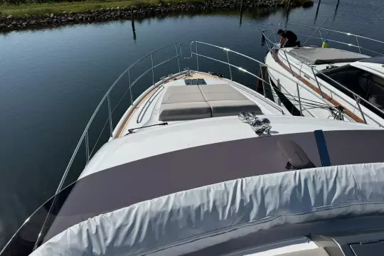 2024 Princess F50 yacht docked in calm waters, showcasing sleek design and luxury features.