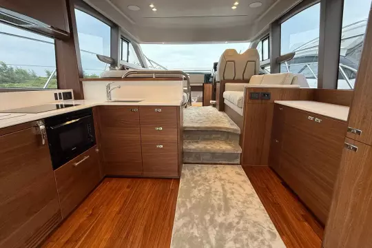 Luxurious interior of 2024 Princess F50 yacht with modern kitchen and seating area.