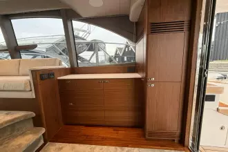 Luxurious interior of 2024 Princess F50 yacht with elegant wood cabinetry and plush seating.