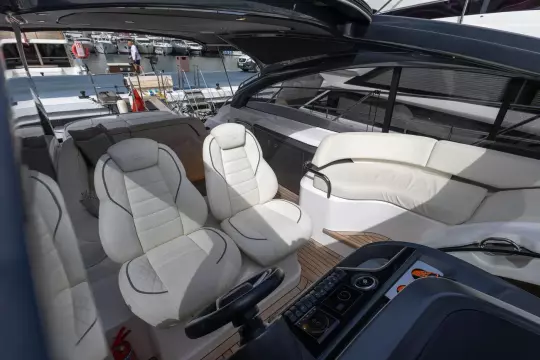 Luxurious interior of 2023 Princess V50 Open yacht with elegant white seating.