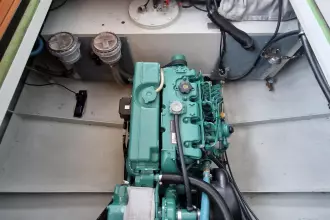Engine compartment of a 2008 Linssen 33.9 AC boat, showcasing a green marine engine.