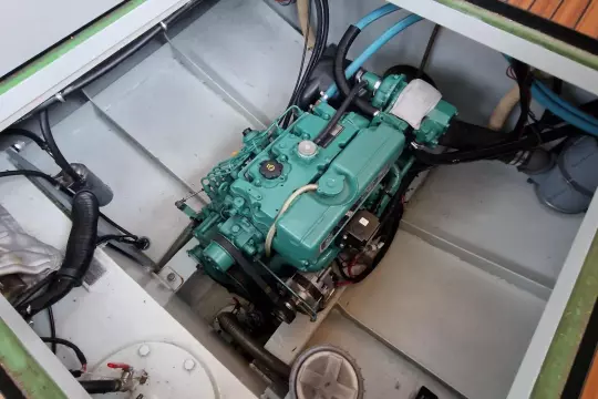 Engine compartment of a 2008 Linssen 33.9 AC boat, showcasing a green marine engine.