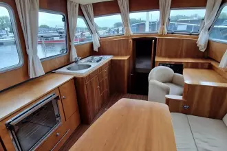 Interior of 2008 Linssen 33.9 AC yacht with wood finish and kitchenette.