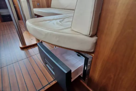 Interior of 2008 Linssen 33.9 AC yacht with open storage drawer under cushioned seating.